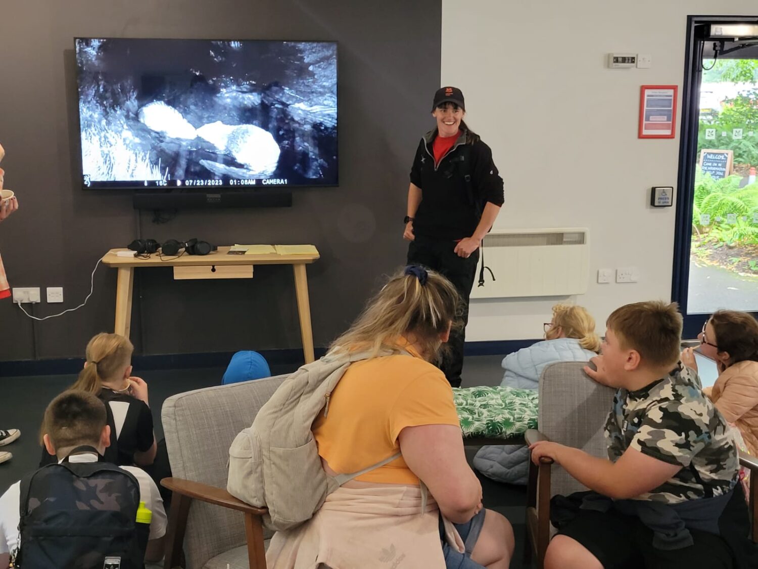 Young people watching video footage of Beavers during a trip funded by the Lantern Fun